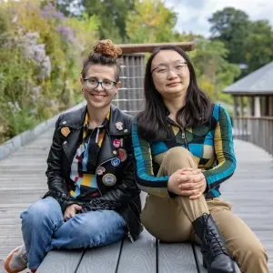 Shiya Cao and Heather Rosenfeld sit on a bench near Paradise Pond